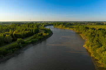 Aerial view of the Scheldt river, at sunset, in Baasrode, East Flanders, Belgium