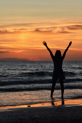 silhouette of person jumping on the beach