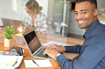 Multiracial staff at work in cowork office separatd with plexiglas protection