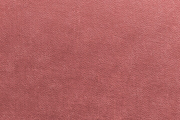 The surface of the brown old worn dermatin with a small pattern.