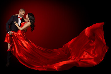 Happy Dancing Couple Portrait, Woman in Red Silk Gown and Handsome Beard Man in Suit, Flying Waving Fabric