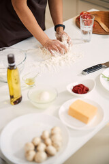 Obraz na płótnie Canvas Woman preparing perfect dough for homemade pizza