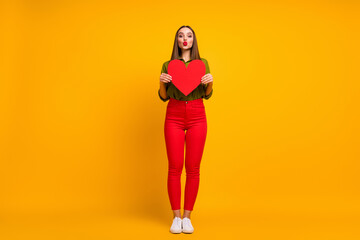 Fototapeta na wymiar Full length body size view of nice straight-haired girl holding in hands heart sending air kiss isolated on bright yellow color background
