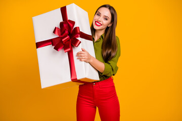 Portrait of gorgeous cheerful straight-haired girl holding in hands big large giftbox isolated over...