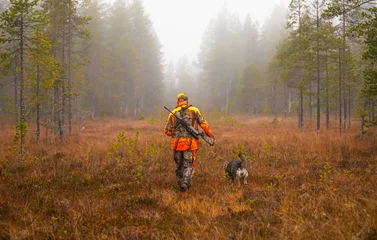 Foto op Plexiglas Hunter and his elkhound outdoor in the wilderness © RobertNyholm