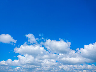 Obraz na płótnie Canvas Bright blue sky with clouds and creative text input space