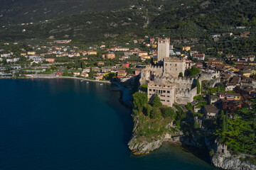 Fototapeta na wymiar Malcesine town, Lake Garda, Italy. Panoramic aerial view of Scaliger Castle in Malcesine, Malcesine town. Italian resort on Lake Garda, Monte Baldo.