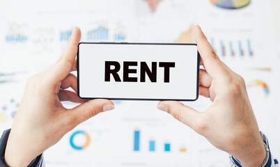 Closeup on businessman holding a smartphone with text RENT.