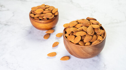 Almonds in wooden bowl on the table.Healthy food Concept.