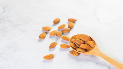 Almonds in wooden spoon on the table.Healthy food Concept.
