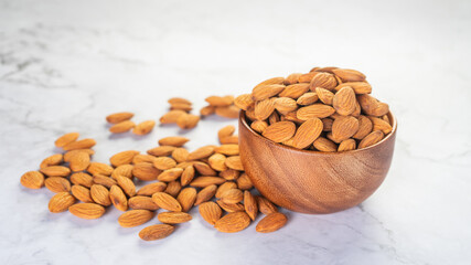 Almonds in wooden bowl on the table.Healthy food Concept.