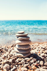 Fototapeta na wymiar Smooth pebble stones on the shore of the island - peace and loneliness inner spiritual balance