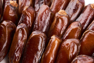 Creative layout made of dried dates. Flat lay. Food concept. Fruits dates. Dates Palm fruit isolated on white. Dried fruits. Healthy diet.