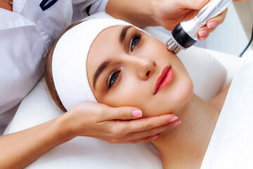 Photo vacuum rf face lifting. Biostimulation in a beauty salon. Skin rejuvenation. Radio wave...