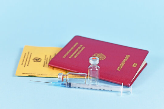 Concept for travel restrictions for people without corona virus vaccination with international certificate of vaccination, German travel passport, syringe and vials