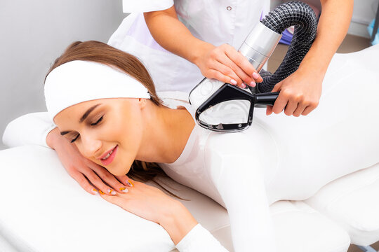 Photo lipomassage LPG. LPG procedure massage the patient in a white suit.