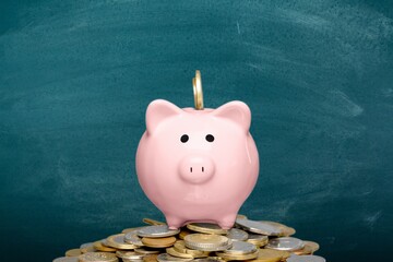 Piggy bank and golden coins on background