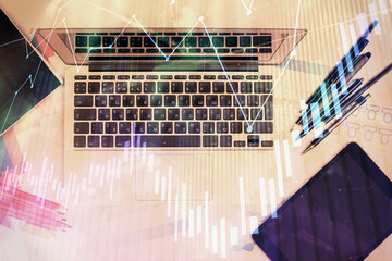 Multi exposure of forex chart drawing over table background with computer. Concept of financial research and analysis. Top view.