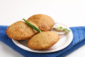 Kachori, green chilly and onion slice in plate. kachori is a spicy snack from India also spelled as kachauri and kachodi. Favorite Tea time snacks