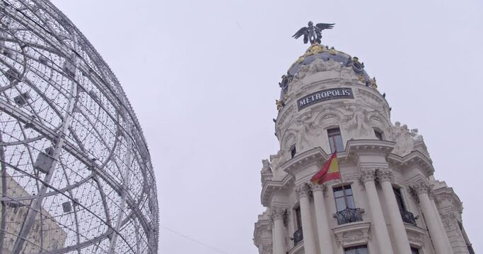 MADRID - JANUARY 8, 2021:  Iconic metropolis building in the city center during the blizzard Filomena.