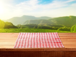 Empty wooden table with red tablecloth