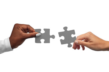 communication, cooperation and people concept - black and white hands matching pieces of puzzle