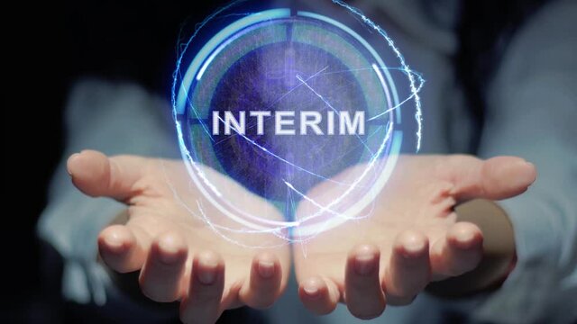 Female hands show a round conceptual hologram with text INTERIM. Unrecognizable woman in ashen white on a black background with future holographic technology