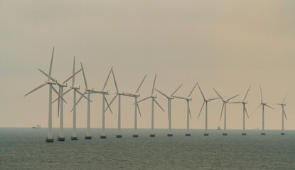 Massive offshore wind turbines  generating clean green energy from ocean winds.