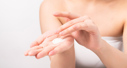 Close up of woman hand holding and applying moisturiser, Body lotion, isolated on white background.