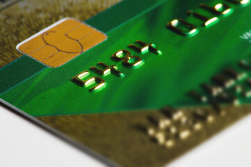 Close-up shallow depth of field credit card with microchip on the background of columns of metallic...
