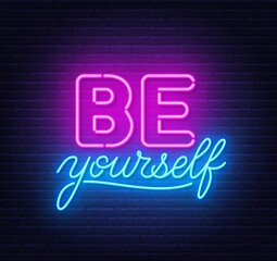 Fototapeta na wymiar Be yourself neon quote on a brick wall. Inspirational glowing lettering.