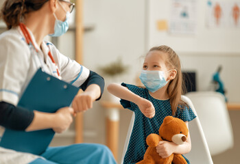 Doctor and child wearing facemasks