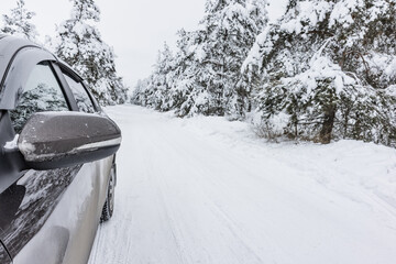 tire on a winter snow-covered road in the forest, winter landscape