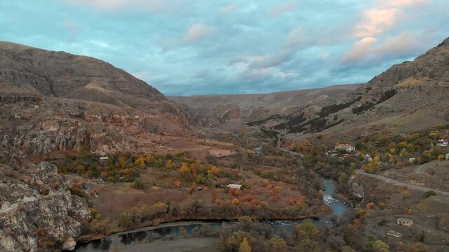 Scenic aerial view of Vardzia mountainous landscape with river and dramatic sky background