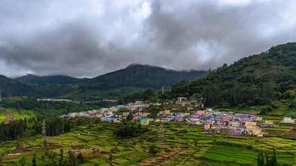 Fototapeta premium ooty village of green mountains landscape with sky and clouds . Ooty or Ootacamund or Udhagamandalam is a popular hill station in India