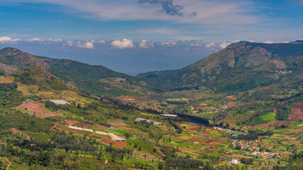 ooty village of  green mountains landscape with sky and clouds . Ooty or Ootacamund or Udhagamandalam is a popular hill station in India