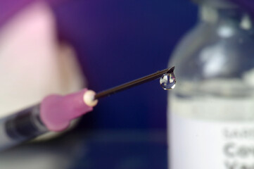 Vaccine Covid-19 dose glass vial and filling the syringe