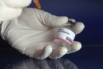 Vaccine Covid-19 dose glass vial and filling the syringe