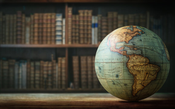 Old globe on bookshelf background. Selective focus. Retro style. Science, education, travel, vintage background. History and geography team.