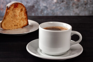 Cup of coffee with cream with a slice of freshly baked homemade muffin