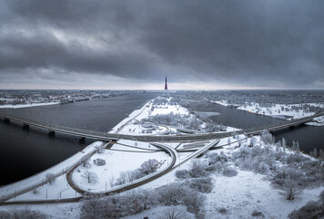Riga television tower in winter. Soviet architecture. Skyscraper on island covered in snow. 

