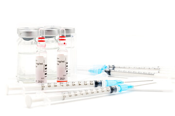 Medical syringes and needles for hypodermic injection. The Right hand Red Vial is point of focus