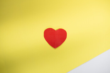 Red heart shape on yellow background.