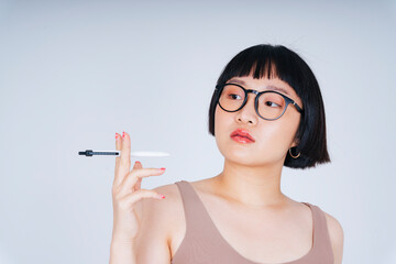 Young asian woman short bob hairstyle wearing sunglasses holding pen isolate on white background.