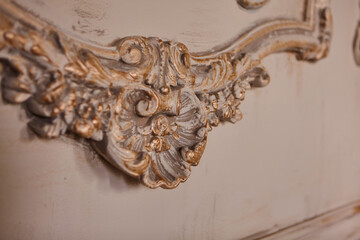 Beautiful white stucco patterned on the boundary wall. Vintage white wall bas-relief stucco in plaster.