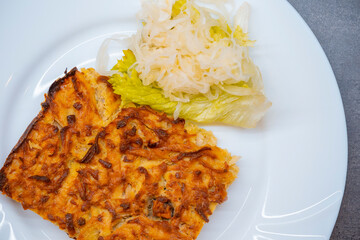 Cabbage pancake with potatoes and bacon, health food on plate