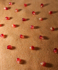 pattern of beautiful ripe pomegranates close-up on an orange background