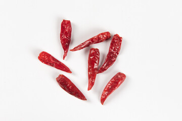 Dry red hot chili peppers, pile isolated on white background