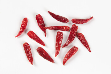 Dry red hot chili peppers, pile isolated on white background