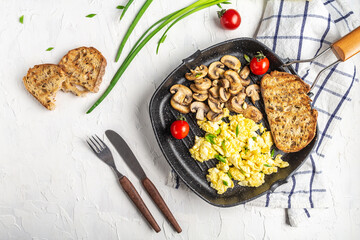 Fried egg on a frying pan. Salted and spiced fried egg with champignon mushrooms on cast iron pan and light background. banner, menu recipe place for text, top view